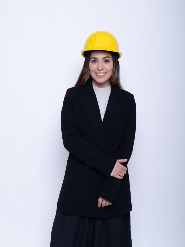 Valentina Sanchez in a yellow hard hat and black blazer, smiling